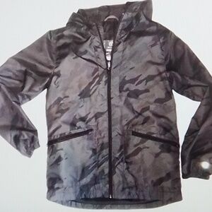 Champion Camouflage print raincoat with zipper pockets and hood. Size M(8-10)